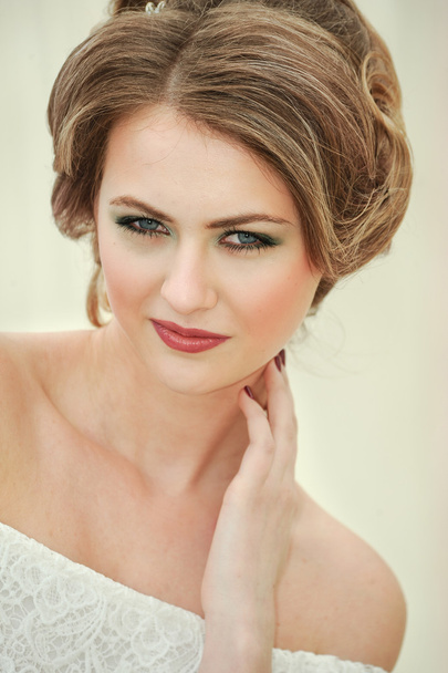 Attractive young woman with romantic hairstyle and professional make-up - Foto, Imagem
