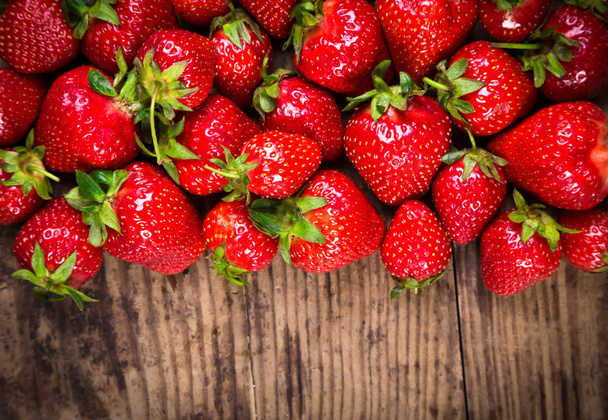 food background with strawberry on wood table - Foto, Imagen
