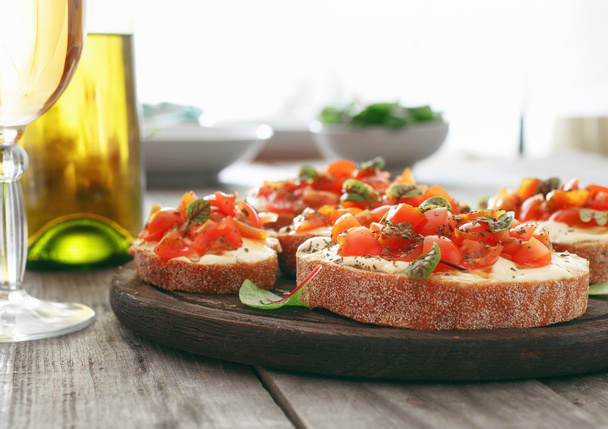 Bruschetta with tomatoes, goat cheese and basil - 写真・画像