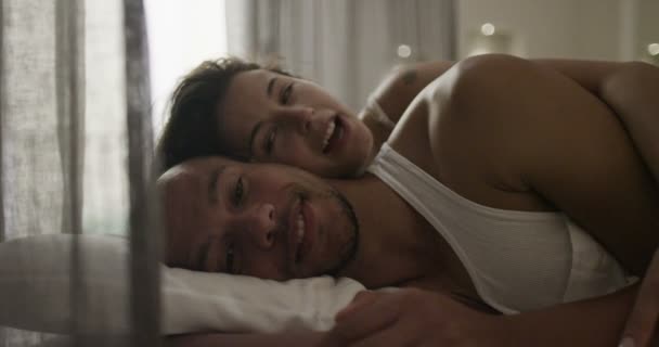 couple talking in bed - Materiał filmowy, wideo