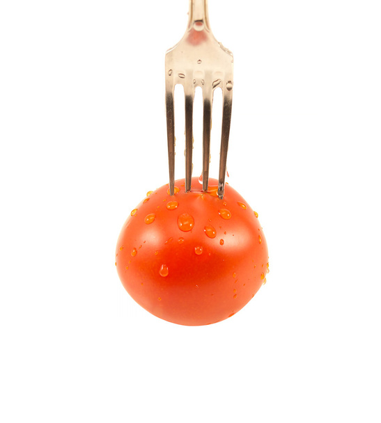 Ripe red tomato and fork  - Zdjęcie, obraz