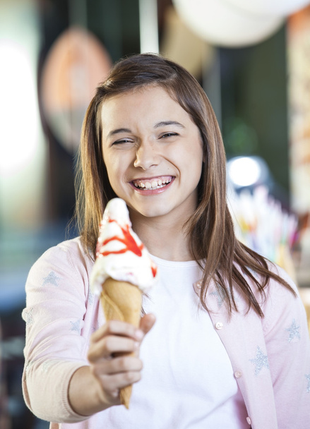 Girl Showing Delicious Ice Cream With Strawberry Syrup - Photo, Image
