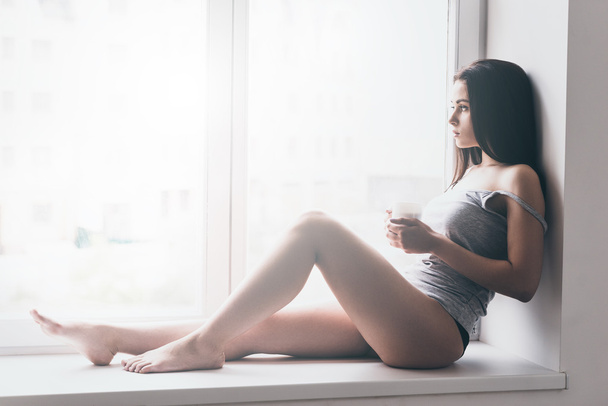 Beautiful woman in panties on windowsill - Фото, зображення