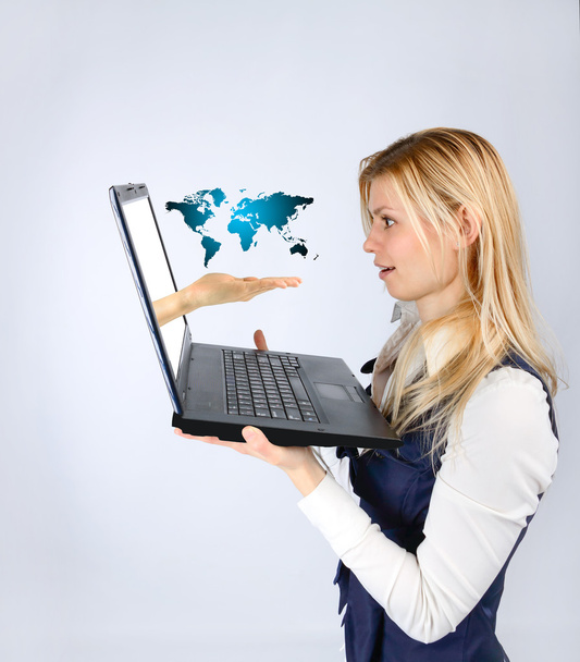 Business woman holding a laptop and tourism advertising in the world - Foto, Bild