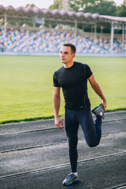 man stretches before running - 写真・画像