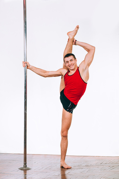 Young strong pole dance man - Foto, Imagen