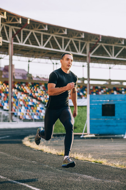 Runner on the track at a sport stadium - Photo, Image