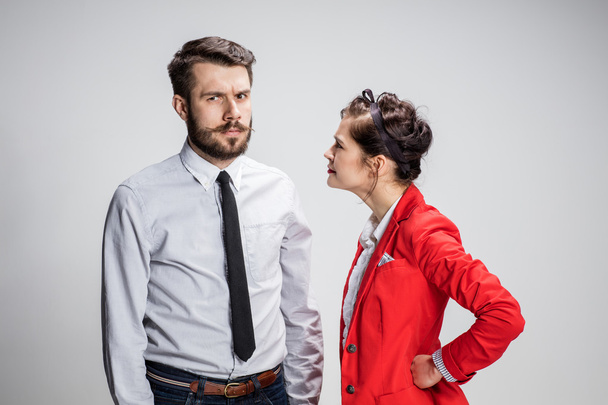 The business man and woman conflicting on a gray background - Photo, image