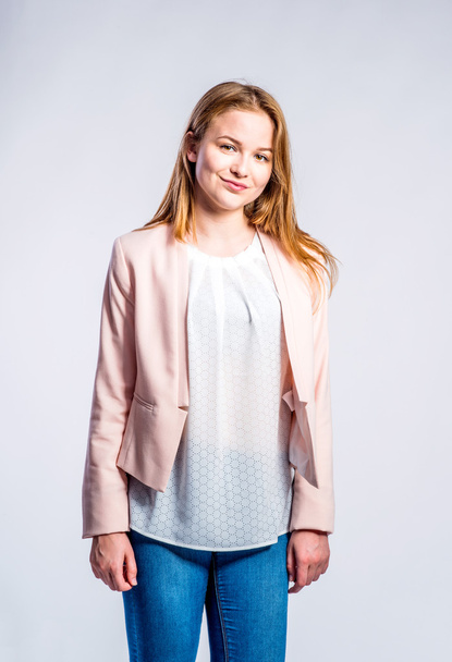 Girl in jeans and pink jacket, woman, studio shot - Foto, afbeelding