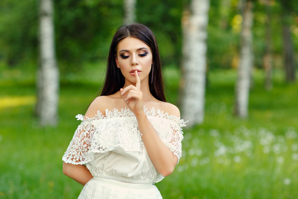 Portrait of beautiful sensual brunette girl in white dress, put  - Fotografie, Obrázek