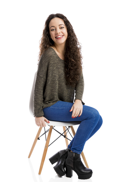 Happy woman sitting on a chair - Photo, Image