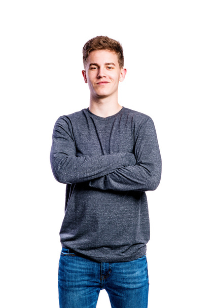 Boy in jeans and sweater, young man, studio shot - Photo, image
