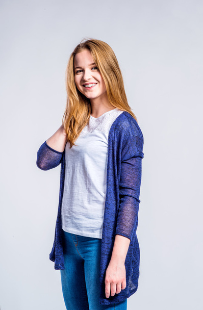 Girl in jeans and long sweater, woman, studio shot - Photo, Image