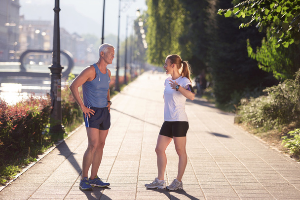 couple warming up and stretching before jogging - Valokuva, kuva
