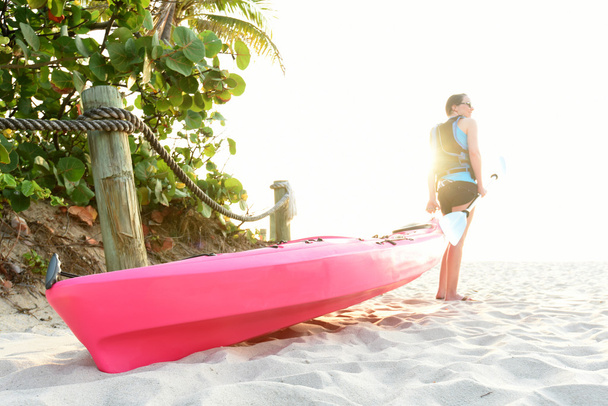 woman on beach with pink kayak - Photo, Image