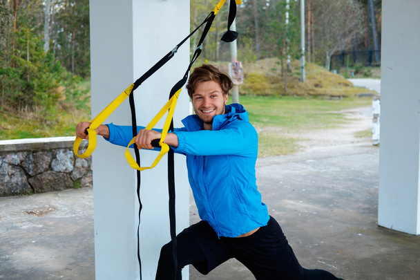 Male exercising with fitness trx strips. - Photo, Image
