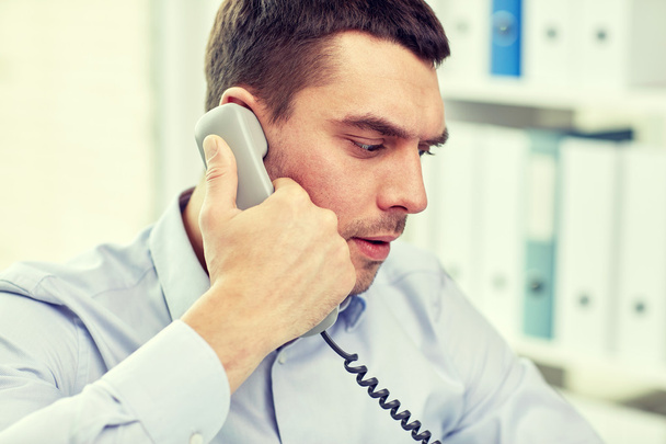 face of businessman calling on phone in office - Valokuva, kuva