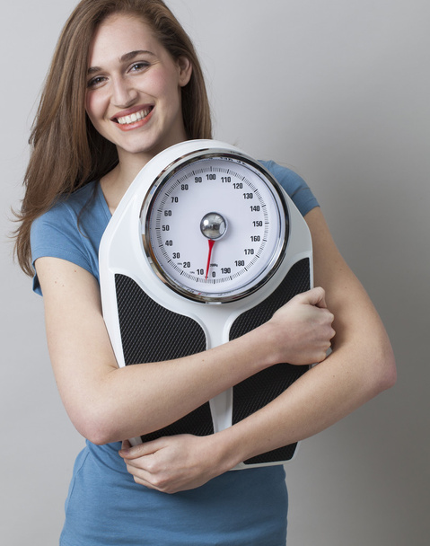 dieting young woman happy at her weight scale and silhouette - Фото, зображення