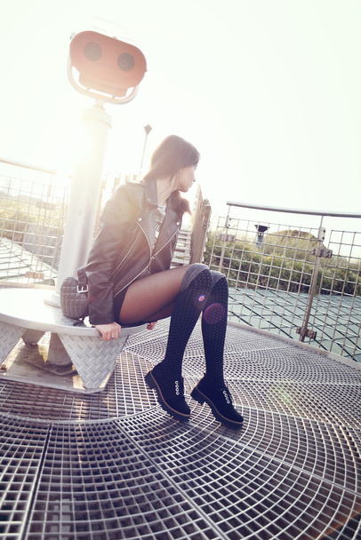 fashion model in sunglasses and black leather jacket posing outdoor - Fotó, kép
