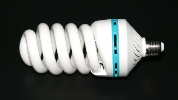 Energy saving lamp isolated on black background. - Footage, Video