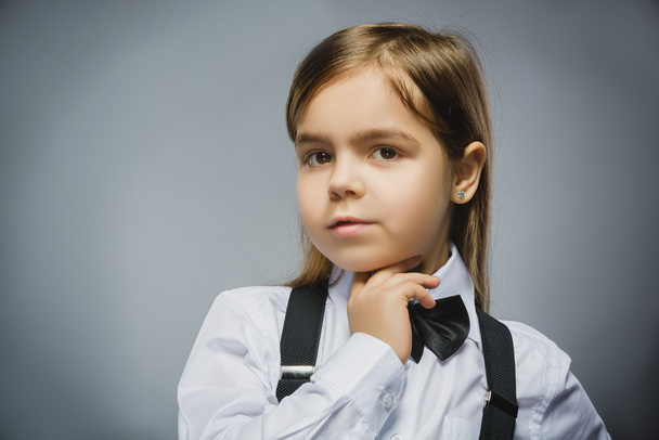 Closeup Thoughtful Young girl Looking Up Against Gray Background - 写真・画像