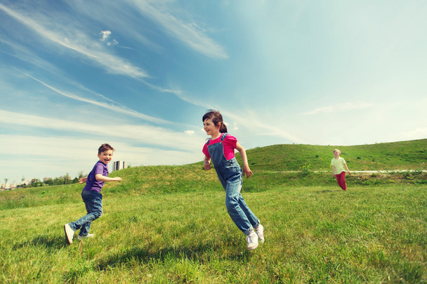 group of happy kids running outdoors - 写真・画像