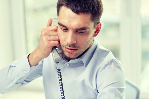 face of businessman calling on phone in office - Foto, afbeelding