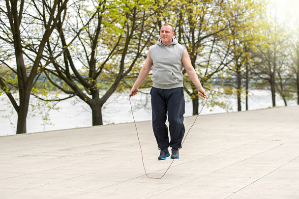 Man with jump rope in park. - Photo, Image