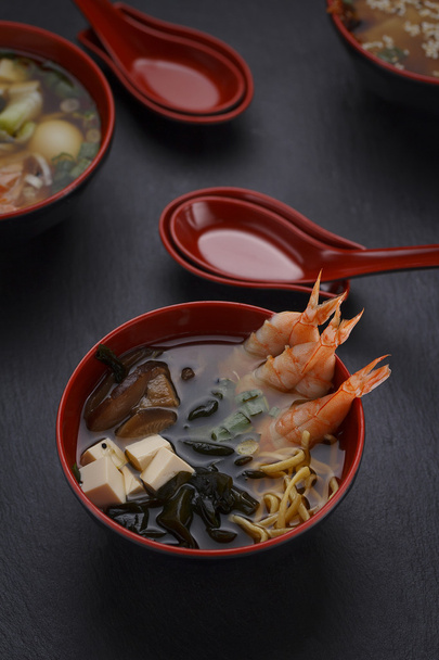 Japanese cuisine. Soup over black background. - 写真・画像