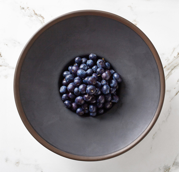 Bowl of blueberry on marble table, from above - Zdjęcie, obraz