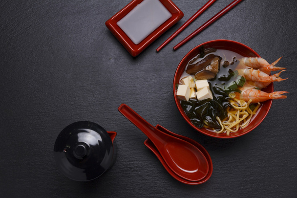 Japanese cuisine. Soup over black background. - Foto, imagen