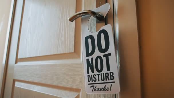Swinging Do No Disturb sign at hotel room door - Footage, Video