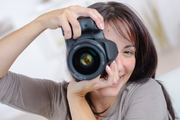 Woman taking a photograph - 写真・画像