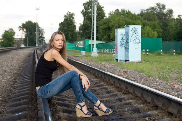 Girl sitting on rails - 写真・画像