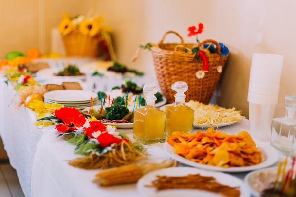 Luxury served catering table of different salty snacks with fancy rural decoration - Foto, immagini