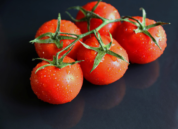 Tasty red tomatoes on stone background - Foto, afbeelding
