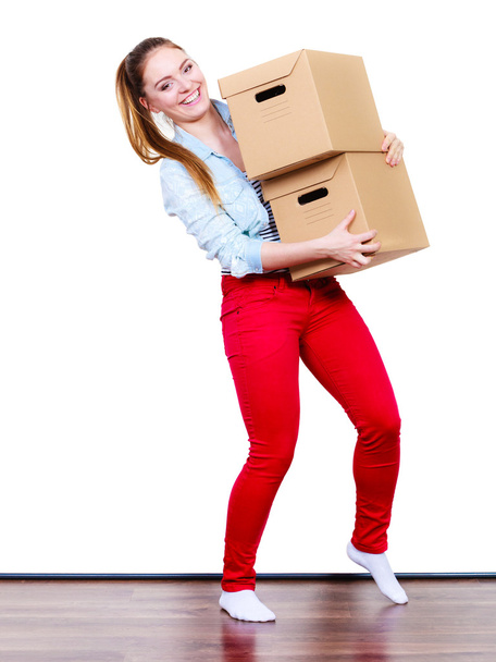 woman moving in carrying  boxes - Фото, изображение