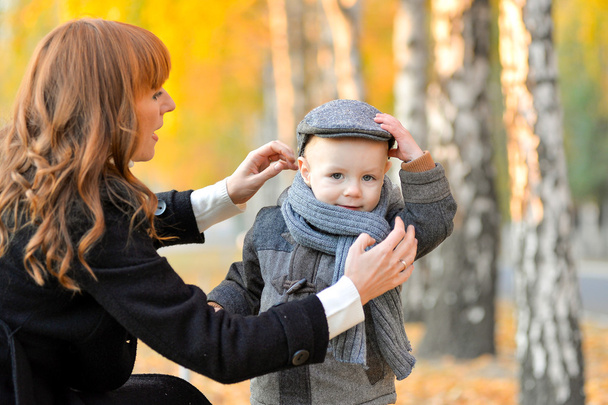 秋の公園で赤ちゃんと母親. - 写真・画像