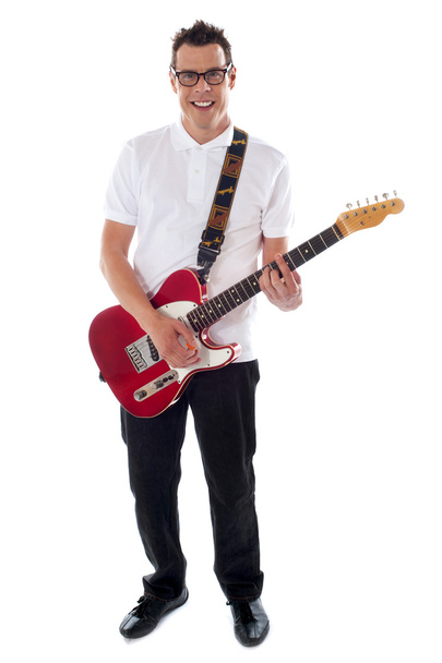 Full shot of a young man with guitar - Fotó, kép