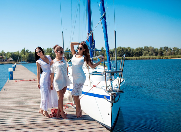 women posing near  yacht - Photo, Image