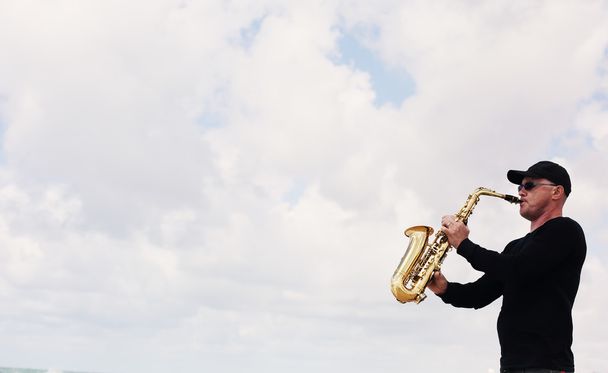 Saxofonist spielt auf dem Saxofon  - Foto, Bild
