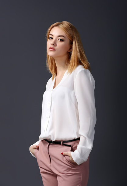 young woman in shirt and pink pants - Фото, изображение