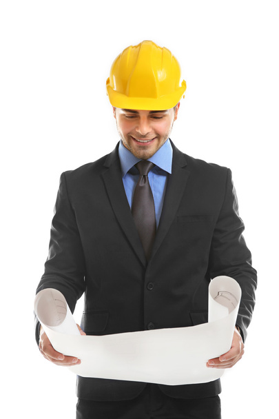 Engineer in helmet holding blueprint  - Foto, Imagen