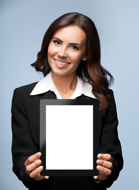 Businesswoman showing blank tablet pc, on grey  - 写真・画像