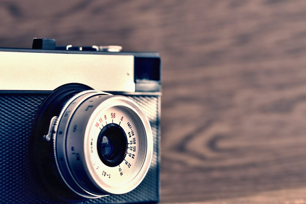 Russian old analog camera on a wooden background. - Photo, Image