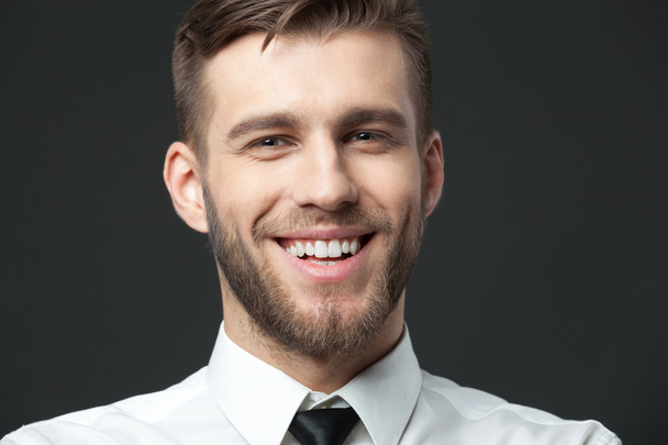 Portait of handsome young businessman smiling with positivity. - Fotografie, Obrázek