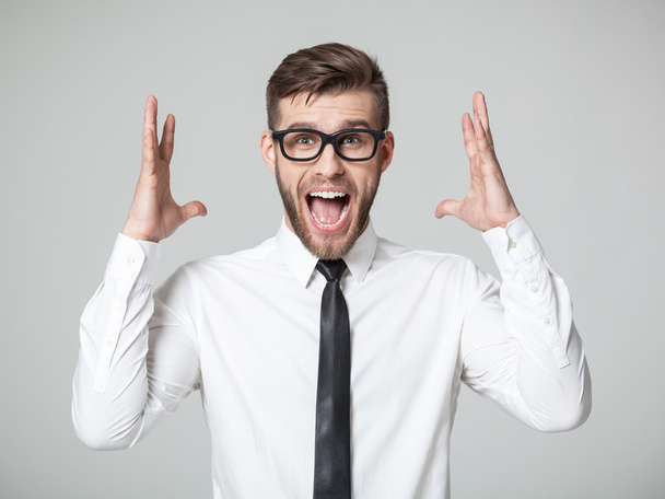 Young businessman screaming at camera isolated. - Photo, Image