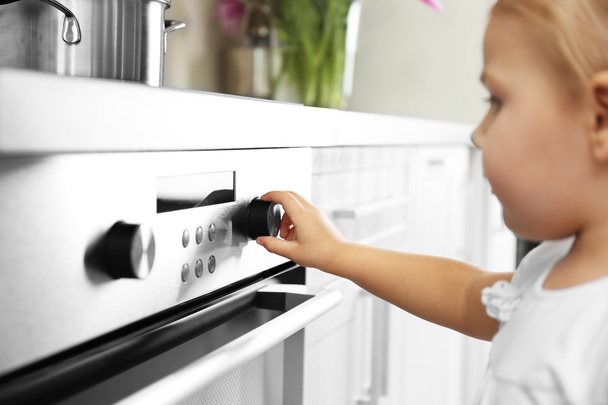 Little girl playing with electric stove - Photo, Image