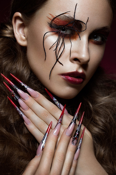 woman in the image of spider with creative art makeup and long nails. Manicure design, beauty face. - Zdjęcie, obraz