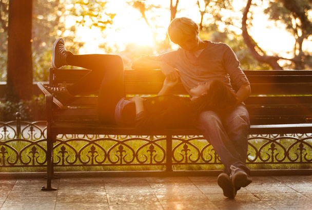 Young couple on the bench at the street. - Foto, Imagem